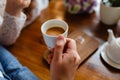 Close up of arms of successful business having a business meeting with his client in cafe. The man in suit is drinking coffee. Mor Royalty Free Stock Photo