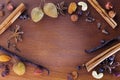 Close up of aromatic Christmas spices and fruits on walnut wooden board