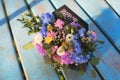 Close-up of adorable flowers arrangement with hydrangea, white eustoma, spray roses, carnations on the blue wooden table Royalty Free Stock Photo