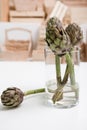 Close up of artichoke bunch flower in glass vase