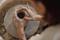 Close up of artisan& x27;s hands shaping clay bowl in pottery studio. Pottery art and creativity Royalty Free Stock Photo