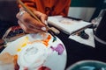 Close up of artist with palette, paint brush and easel painting at studio Royalty Free Stock Photo