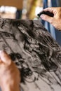Close up of artists hand painting with graphite crayon Royalty Free Stock Photo