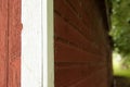 A Close Up Artsy Shot of a Red Barn Wall With White Trim