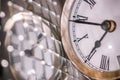 Close up arty shot of a metal large pocket watch clock next to a silver disco ball