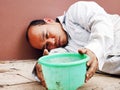 Close-up Asia homeless man sitting on walking street in the capital city. Royalty Free Stock Photo