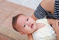 Close-up Asian baby boy lying in hug of mother with looking camera Royalty Free Stock Photo