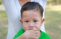 Close up Asian baby boy sucking finger in mouth Royalty Free Stock Photo