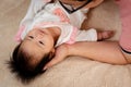 Close-up of Asian baby girl face, lying on a soft brown bed, And the father cherishes the little boy`s hand, and sleeps with his Royalty Free Stock Photo