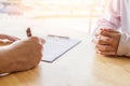 Close-up. Asian business of hand holding pen reviewing and signing,Home buying contract,Selective focus Royalty Free Stock Photo