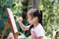 Close up of Asian child girl is painting on the canvas.