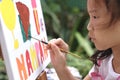 Close up of Asian child girl is painting on canvas. Royalty Free Stock Photo