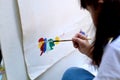 Close up of Asian child girl is painting on white paper. Royalty Free Stock Photo