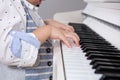 Close up of Asian Chinese little boy`s hand on piano
