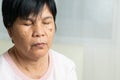 Close-up of Asian elder woman face with wrinkled skin condition