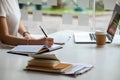 Close up asian female is taking notes on her notebook for online classes, study ideas and note-taking. Education Online Royalty Free Stock Photo