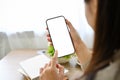 Close-up, Asian female using her smartphone. a woman holding a mobile phone white screen mockup Royalty Free Stock Photo