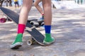 Close-up Asian girl surf skate or skateboard outdoors on beautiful morning. Happy young girl play surf skate at ramp park on