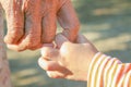 Close up asian grandmother and grandchild holding hands