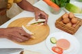 close-up asian hand egg sandwich decoration After using a knife to cut a sandwich that was placed on a wooden chopping board. To Royalty Free Stock Photo