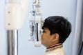Close up asian Little boy eye exam with diagnostic ophthalmology in optical clinic. professional ophthalmic checking vision of Royalty Free Stock Photo