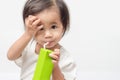 Close up of asian little girl drink pasteurized milk from unidentified brand milk box on a bright background