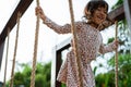 Close up of asian little girl smilling when hold the rope playing balance beam Royalty Free Stock Photo