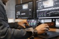 close-up of an Asian male movie video editor or coloris in his creative office studio.