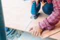 Close up Asian man carpenter using electric saws to cut large board of wood in a construction site. Male worker sawing board. Craf Royalty Free Stock Photo