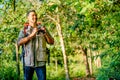 Close up Asian man hold binoculars and carry backpack also look to the right during travel in forest and he look happy Royalty Free Stock Photo