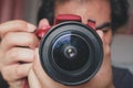 Close up of Asian man photographer who hold camera and taking shot of photo Royalty Free Stock Photo