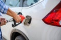 Close-up Asian man refueling his car at a self-service gas station Royalty Free Stock Photo