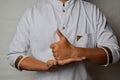 Close up Asian man shows hand gestures it means HELP isolated on white background. American sign language