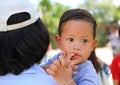 Close up Asian mother carrying her son with sucking finger in mouth Royalty Free Stock Photo