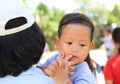 Close up Asian mother carrying her son with sucking finger in mouth Royalty Free Stock Photo