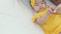 Close up of asian mother holding her newborn baby`s hand on the bed in the morning Royalty Free Stock Photo