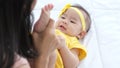 Close up of asian mother kissing her newborn baby`s feet and sunlight in the morning Royalty Free Stock Photo