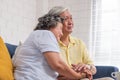 Close up Asian senior couple encouraging together by holding hand each other at sofa in living room at home.Happy retirement lifes