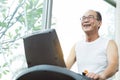 Close up Asian senior man exercising on treadmill machine with c Royalty Free Stock Photo