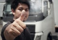 Close-up, Asian a truck driver giving thumb-up with semi truck. Royalty Free Stock Photo