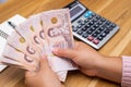 Close up of asian woman with calculator counting money.Woman calculate the spending at home Royalty Free Stock Photo