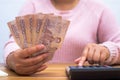 Close up of asian woman with calculator counting money.Woman calculate the spending at home Royalty Free Stock Photo