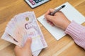 Close up of asian woman with calculator counting money.Woman calculate the spending at home Royalty Free Stock Photo