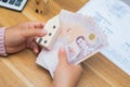 Close up of asian woman with calculator counting money.Woman calculate the spending at home Royalty Free Stock Photo