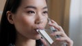 Close up asian woman drinking clean water home delivery holding glass lunch morning daily ritual good habit girl feels