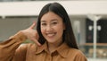 Close up Asian woman happy smiling japanese chinese korean girl businesswoman looking to camera doing phone gesture hey Royalty Free Stock Photo