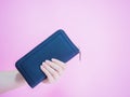 Close up asian woman hold her blue purse by left hand with pink Royalty Free Stock Photo