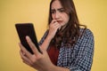 close up of asian woman looking at screen while using a smartphone with worried expression Royalty Free Stock Photo