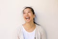 Close up asian woman smiling against by white wall Royalty Free Stock Photo