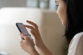 Close up Asian woman using phone, surfing internet, chatting online Royalty Free Stock Photo